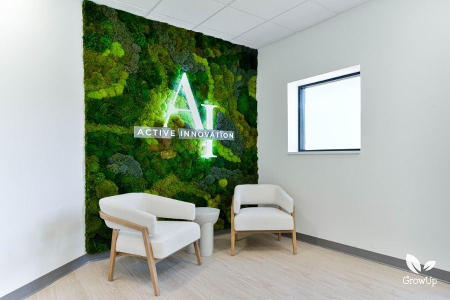 Moss wall with LED logo in white acrylic in an office