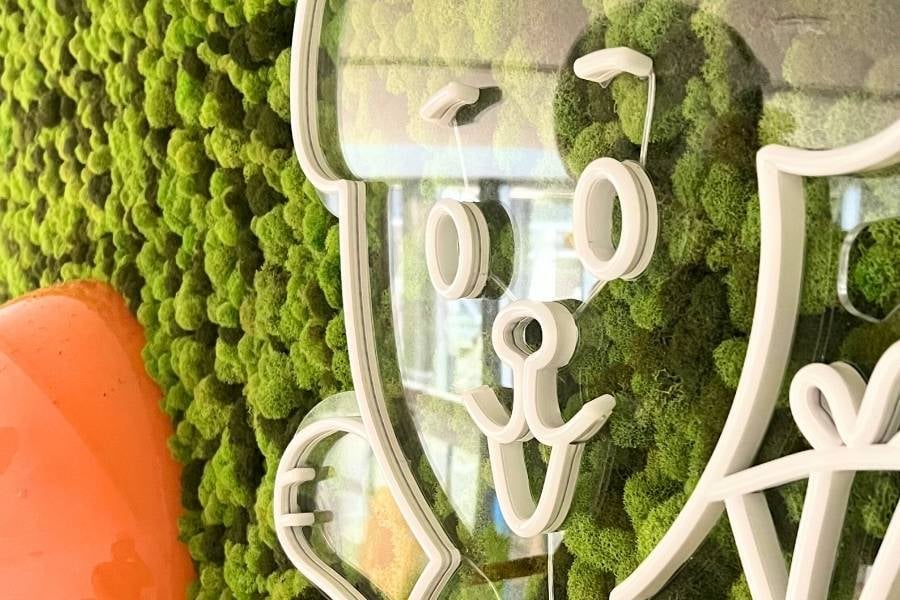 Close-up of GrowUp's custom preserved moss wall at Rady Children's Hospital with the LED bear outline