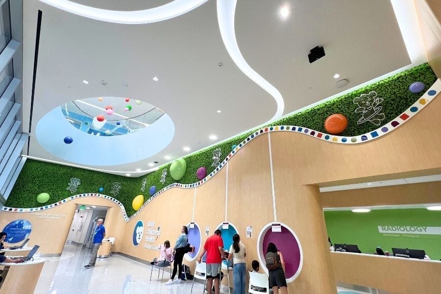 Colorful reindeer moss wall installation at Children’s Hospital of Orange County featuring playful curved design, bright accents, and biophilic elements in the lobby.