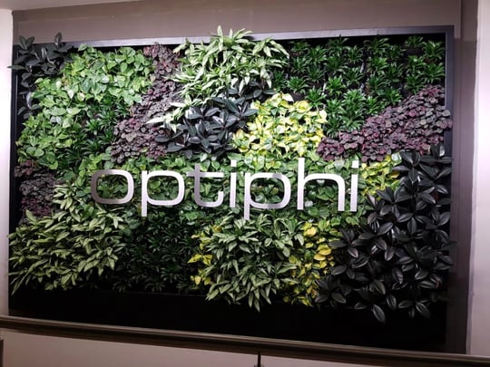 Green wall with logo.