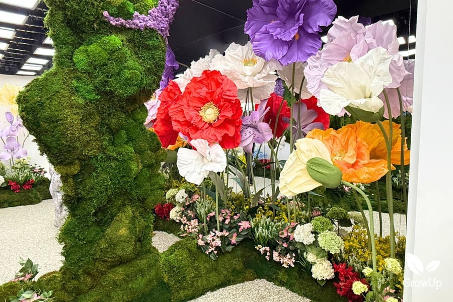 Close up large artificial paper flowers in the moss art installation in the Google Pixel Store
