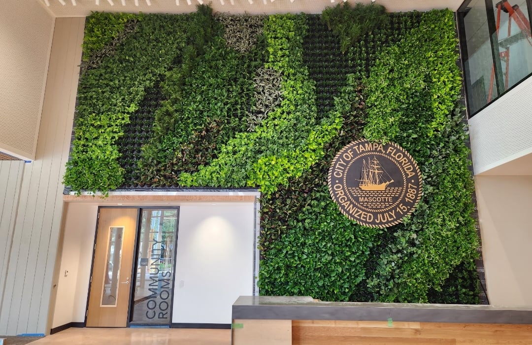 Indoor living wall carrying the City of Tampa seal in the lobby of City Center at Hanna Avenue
