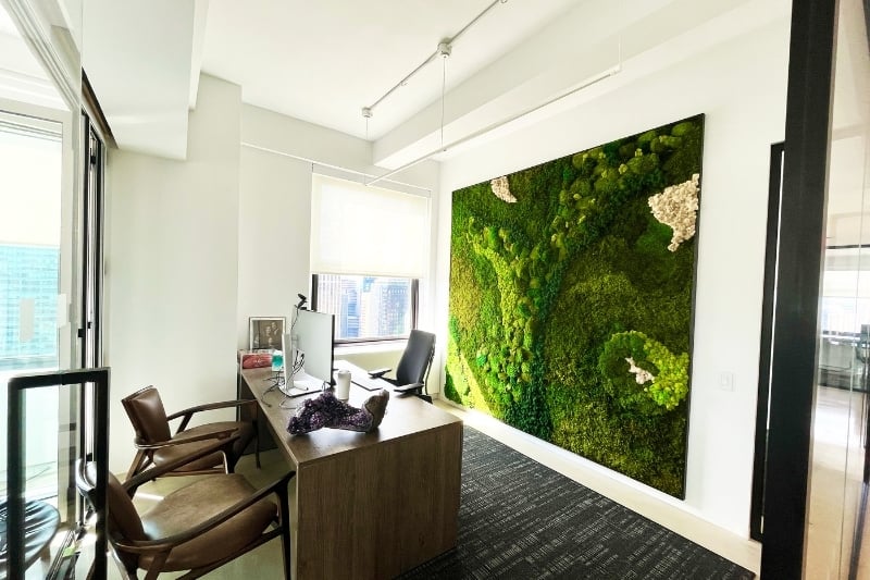 Moss wall behind a desk in an office in a high rise in New York City