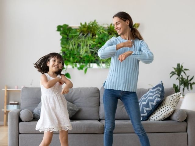 pre-built greenwall in a living room with mother and daughter