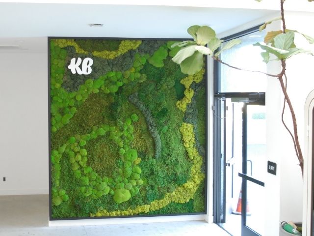 Moss wall with logo in an office