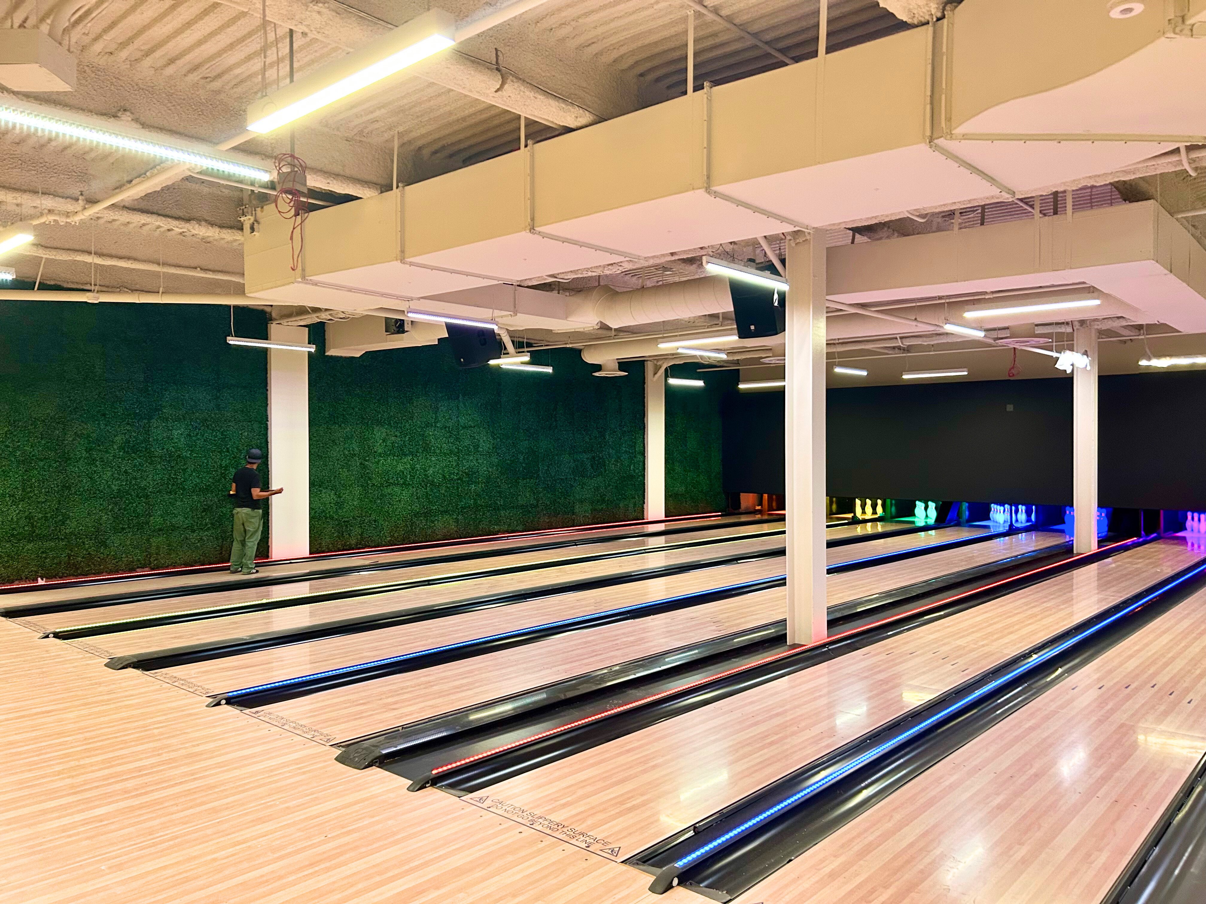 Artificial plant wall covering in a bowling alley