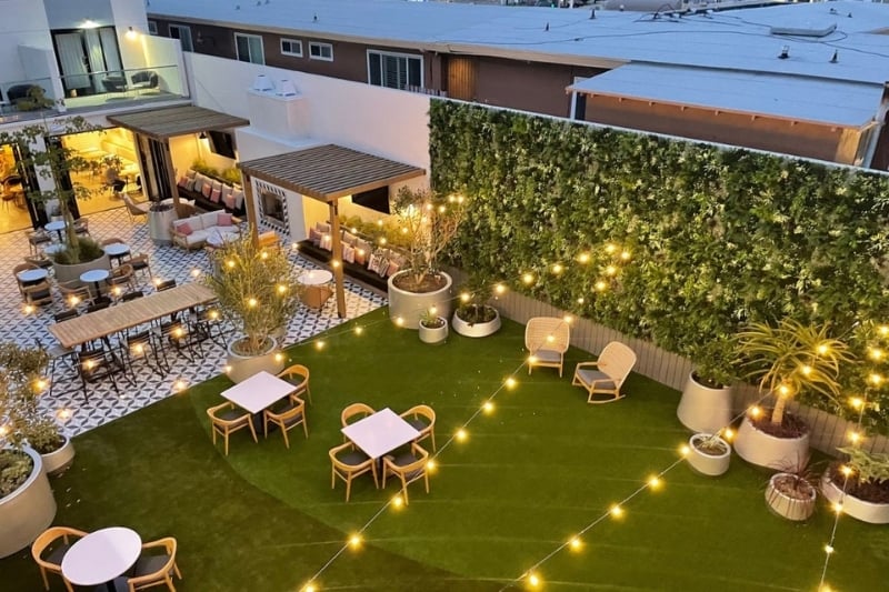 Outdoor entertainment space with large luxury faux greenwall