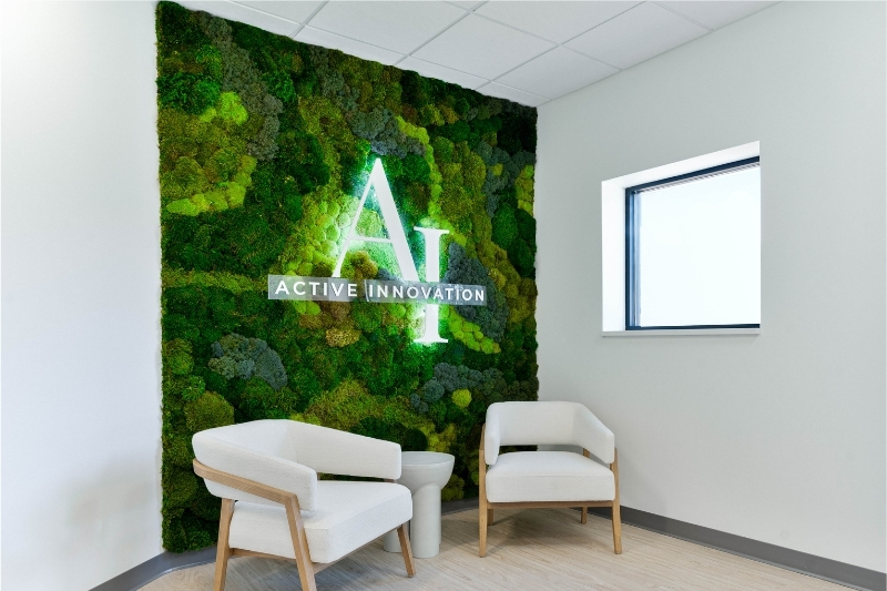 Office entry way with moss wall that has LED logo sign